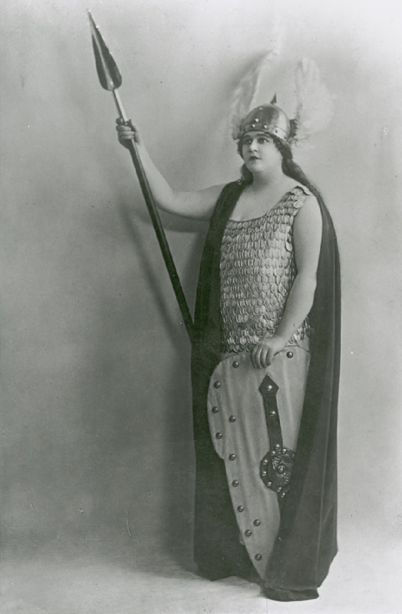 Portrait of Florence Austral dressed as Brunhilde holding a spear and shield.