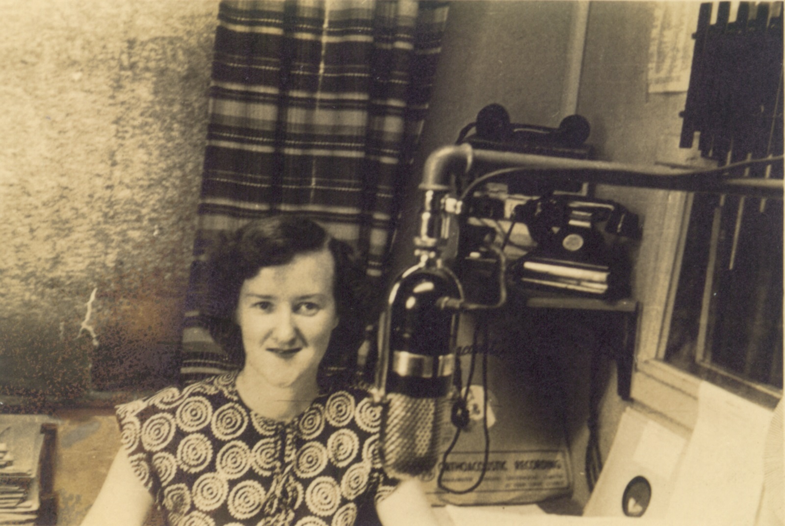 Enid Hogan behind a microphone in a radio studio