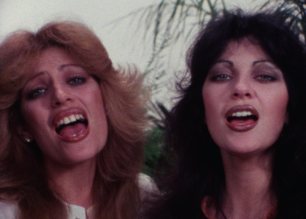 Close up of two women singing.