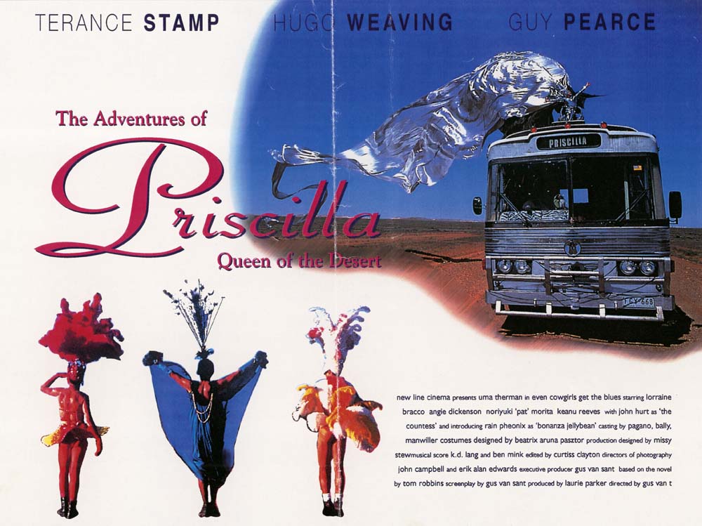 Image of bus travelling across desert with drag queen on top in large, flowing silver costume. Three drag queens in bottom left hand corner.