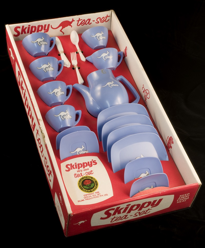 Blue plastic tea set with kangaroo motif in red cardboard box. 