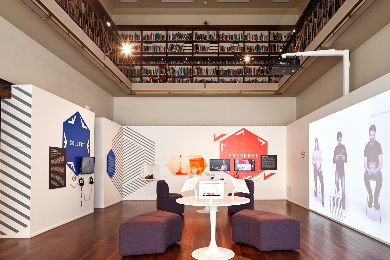 Hive interactive exhibition space with large screens, Ipads and seating.