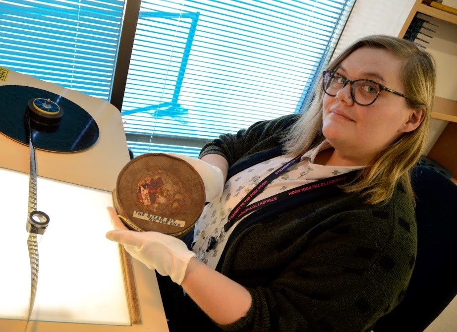 Portrait of Janine Winfree with a can of 28mm at the NFSA.