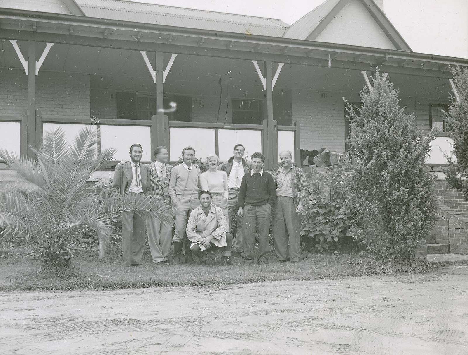 A group shot of cast and crew from the 1951 film Captain Thunderbolt posing in front of a homestead verandah