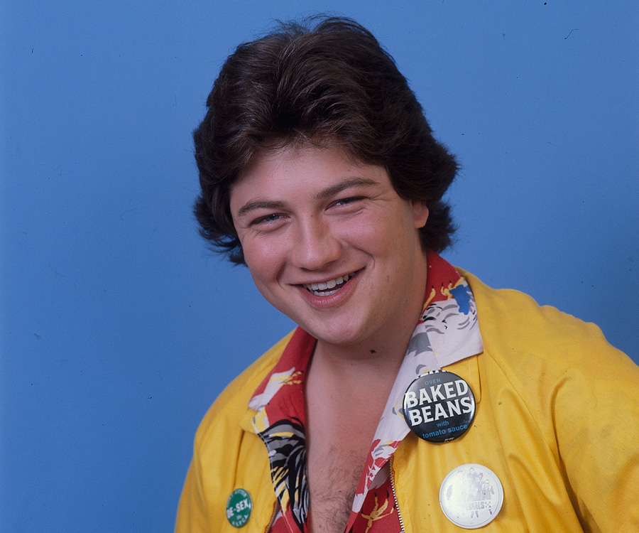 Jonathan Coleman wearing a yellow jacket, smiling at camera.