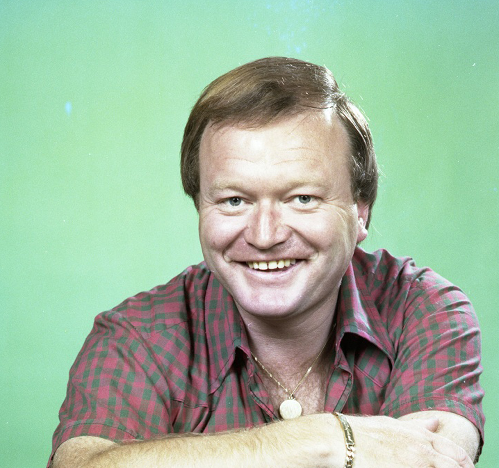 Bert Newton posing in a casual, open-necked shirt