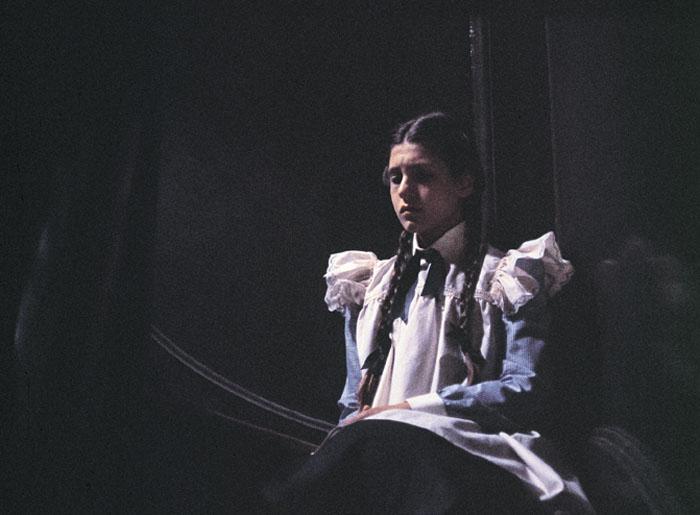 Orphan Sara Waybourne seated on the steps in Appleyard College in a scene from Picnic at Hanging Rock