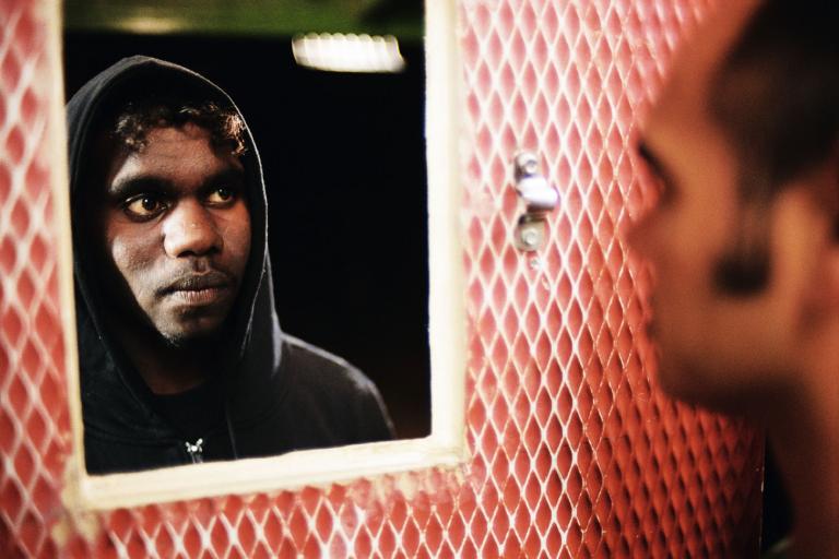 A man looks at himself in the mirror