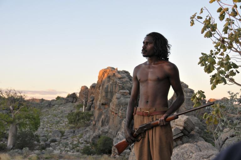 A young man holding a rifle in the Australian outback. A young man holding a rifle in the Australian outback.
