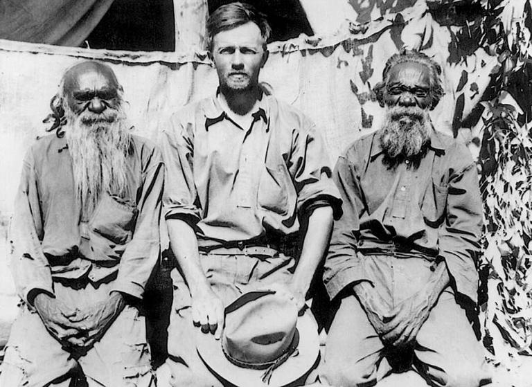 Anthropologist Ted Strehlow and two Indigenous men Anthropologist Ted Strehlow sitting with two older Indigenous men.
