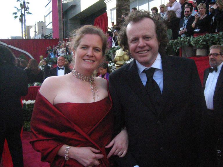 Filmmakers Julia Lucas and Anthony Lucas in formal evening wear on the Academy Awards red carpet, 2006. Filmmakers Julia Lucas and Anthony Lucas in formal evening wear on the Academy Awards red carpet, 2006.