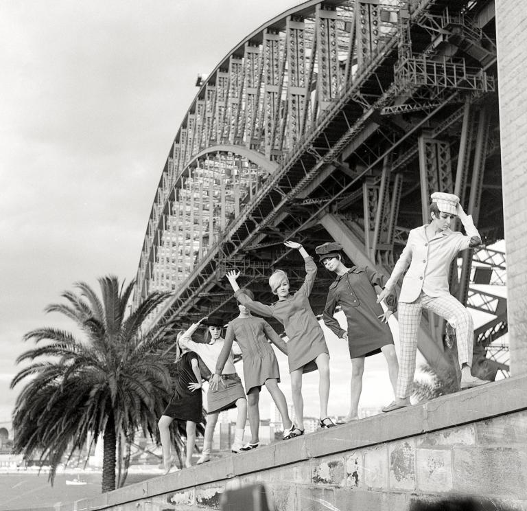 Groovers underneath the Harbour Bridge Black and white photo of six female models dressed in fashion from 1964 posing underneath the Sydney Harbour Bridge