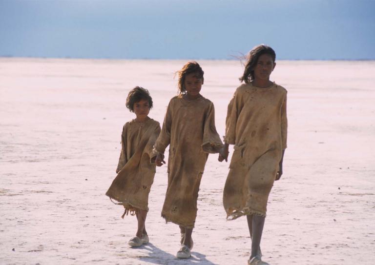 Three girls walk across a salt pan in a still from the film Rabbit-Proof Fence. Three girls walk across a salt pan in a still from the film Rabbit-Proof Fence.