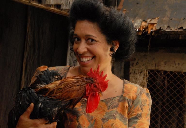 A woman holding a rooster