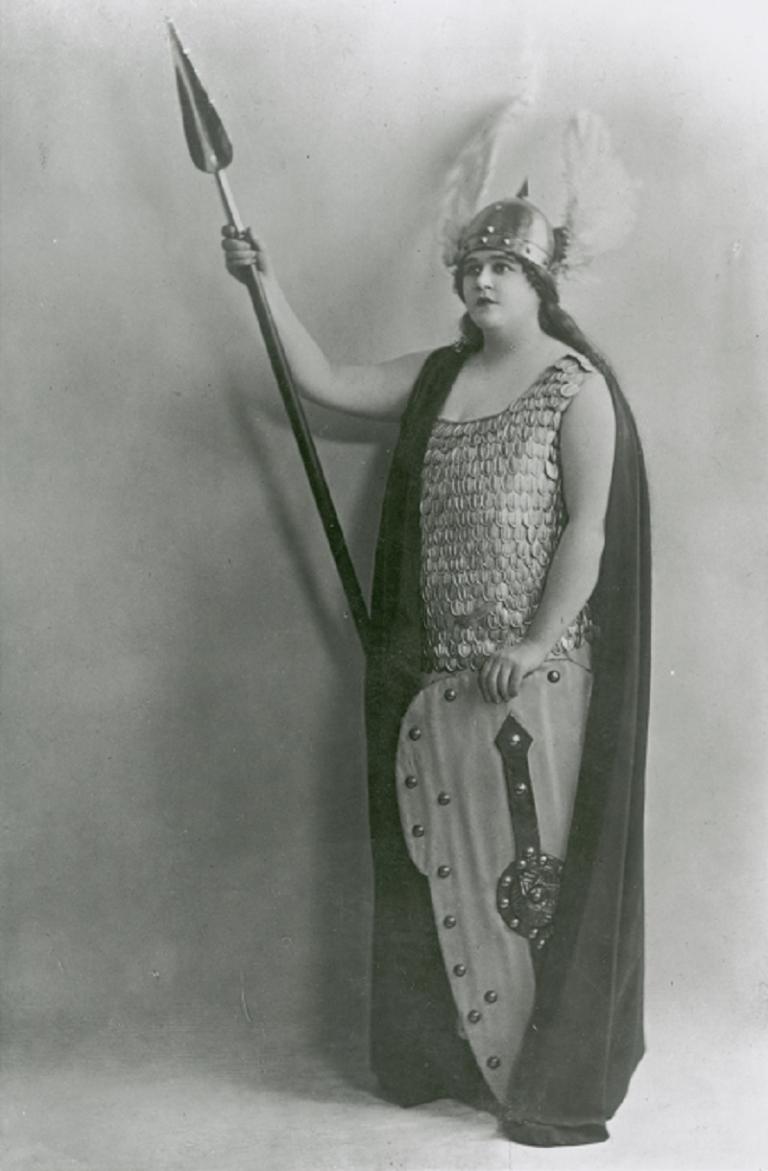 Portrait of Florence Austral dressed as Brunhilde holding a spear and shield.