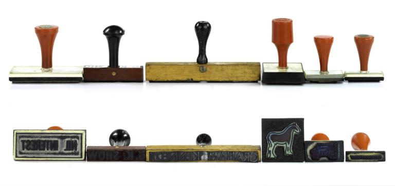 A selection of Graham Kennedy rubber stamps, one reads 'nil interest'