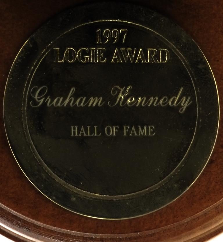 Inscription on Gold Logie reading '1997 Logie Award Graham Kennedy Hall of Fame'