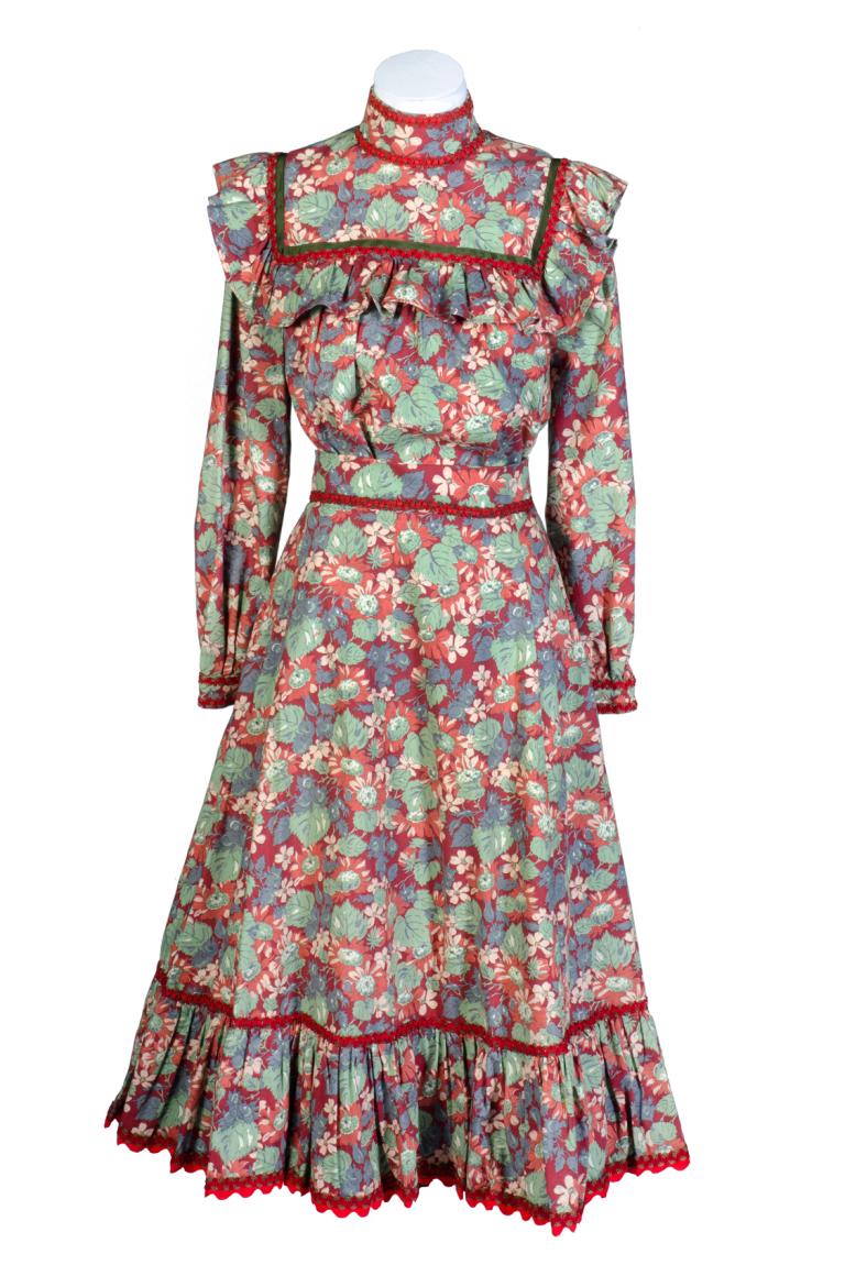 A colourful dress in an early 1900s style with a flower-and-leaf motif and worn on a mannequin A colourful dress in an early 1900s style with a flower-and-leaf motif and worn on a mannequin