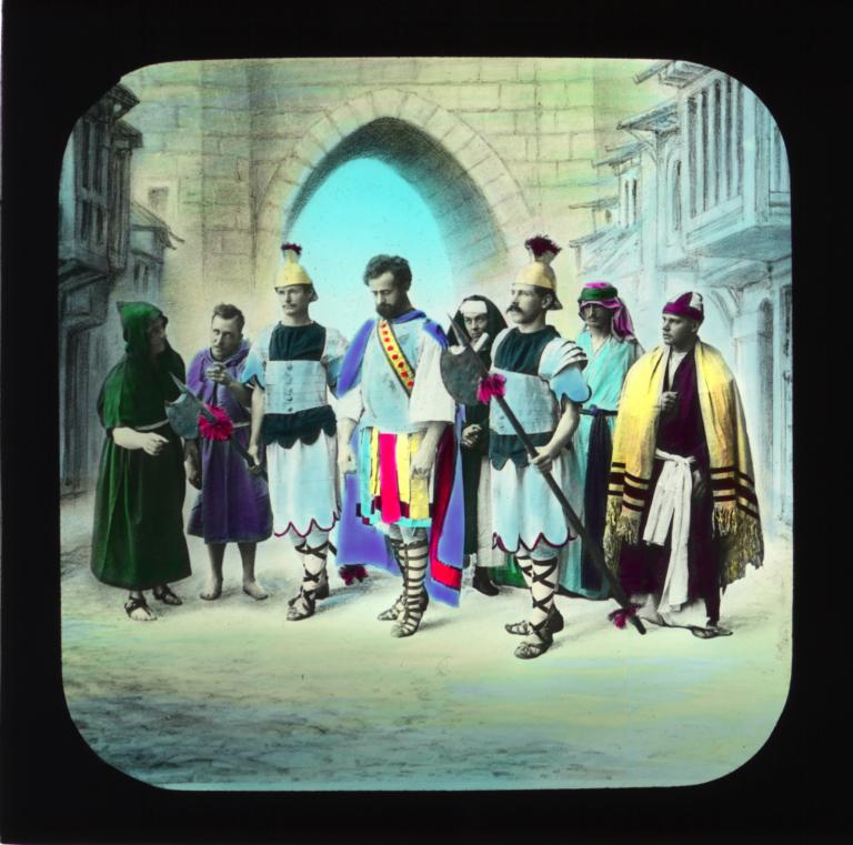 Two Roman soldiers escorting a man past a small crowd of onlookers