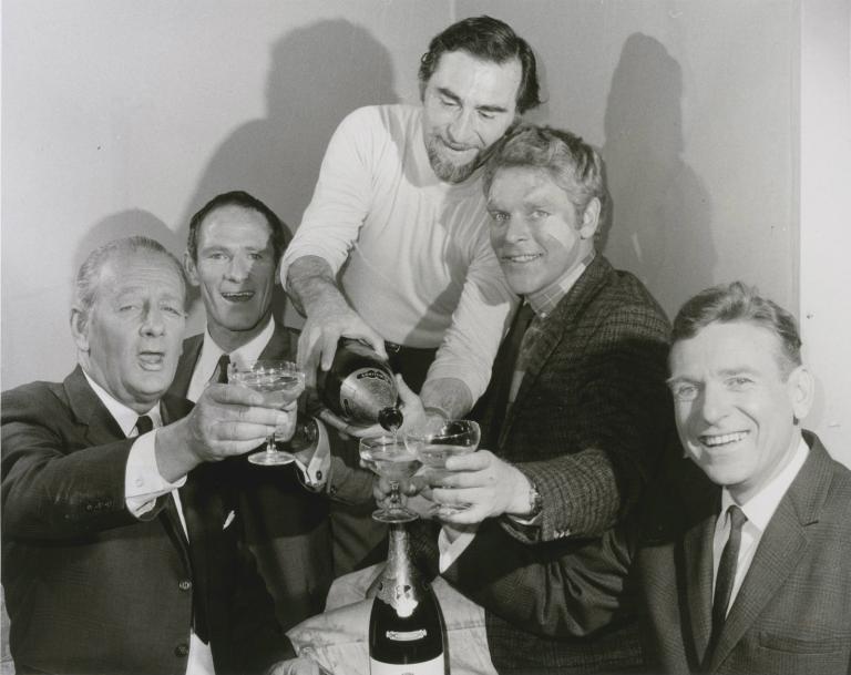 Homicide director Director Alex Emanuel pours champagne for the main cast of Homicide - Alwyn Kurts, Norman Yemm, George Mallaby and Leonard Teale
