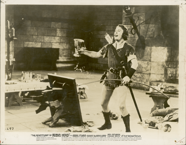 Errol Flynn brandishes an oversized wine goblet