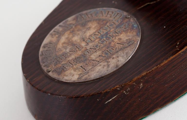 A close up of the base of a TV Week Award, The inscription on it reads '1958 TV Award. Best TV Personality. Panda'.