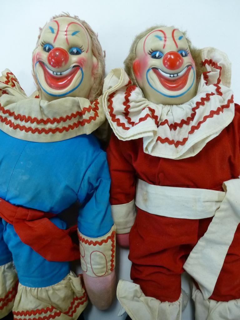 Clown dolls dressed as Bobo Bobo the Clown dolls complete with clown makeup and ruffles around their necks.