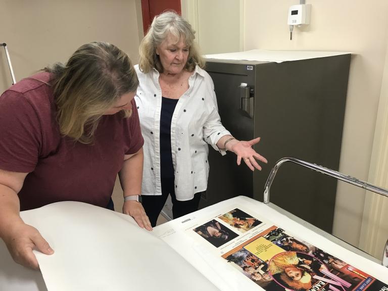 Val Lehmann looks at a poster with NFSA staff person, Belinda Hunt