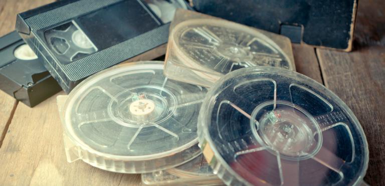 A stack of film reels and video tables scattered on a table