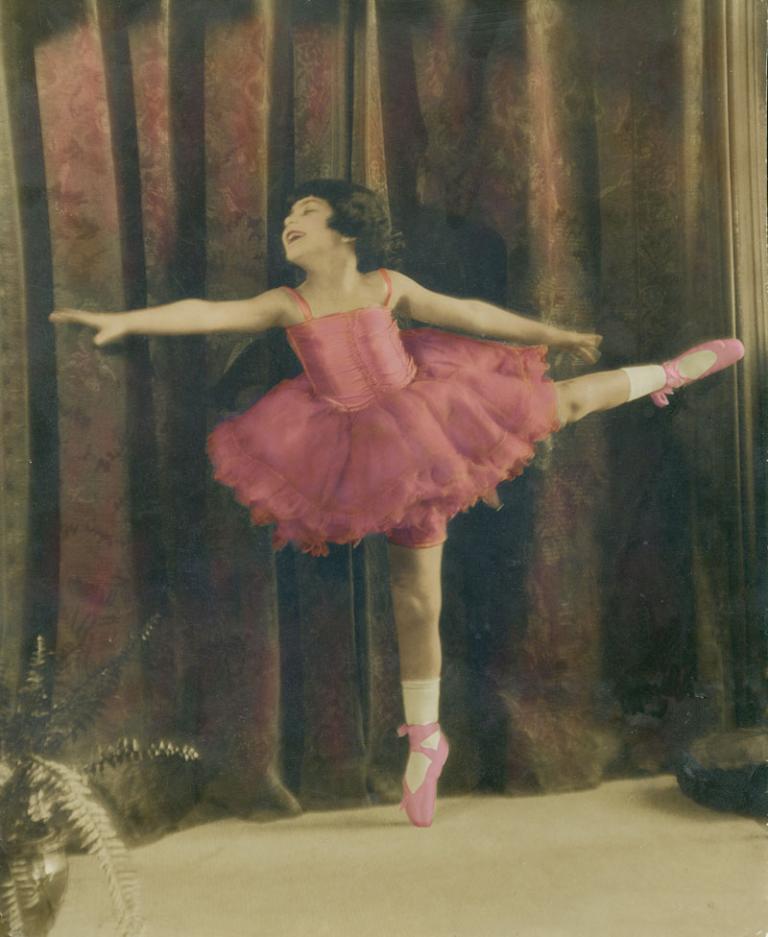 Realising a childhood ballet dream A young girl is wearing ballet tutu and ballet shoes. The photo is a hand-tinted black and white photo.