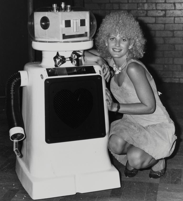 Edith Bliss with Dexter the robot from Perfect Match Wonder World! reporter Edith Bliss poses for a photo with Dexter, the robot from the TV dating show Perfect Match.