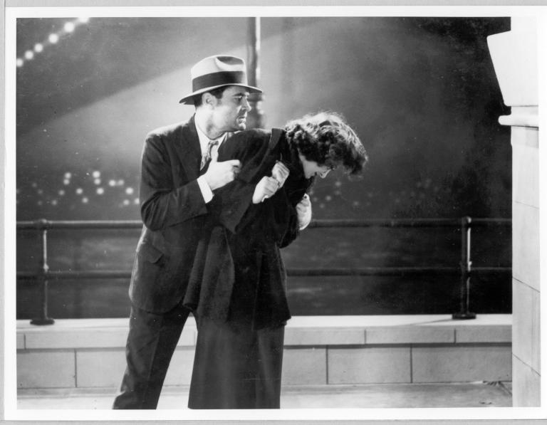 Lloyd Hughes (John Ainsworth) saves an impoverished Diana Du Cane (Ann Brady) from jumping into the harbour in a film still from Broken Melody 