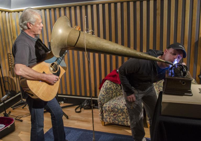 A wax cylinder recording in progress NFSA technician Gerry O'Neill supervises the wax cylinder recording of Keith Potger's song 'Guardian Angel, Guiding Light'