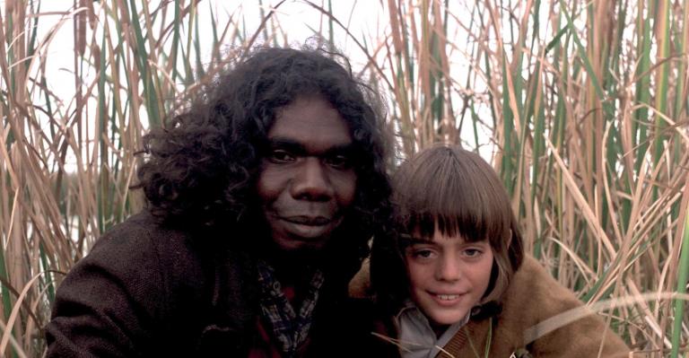 Storm Boy - David Gulpilil and Greg Rowe in long grass David Gulpilil as Fingerbone Bill and Greg Rowe as Storm Boy next to each other in the long grass