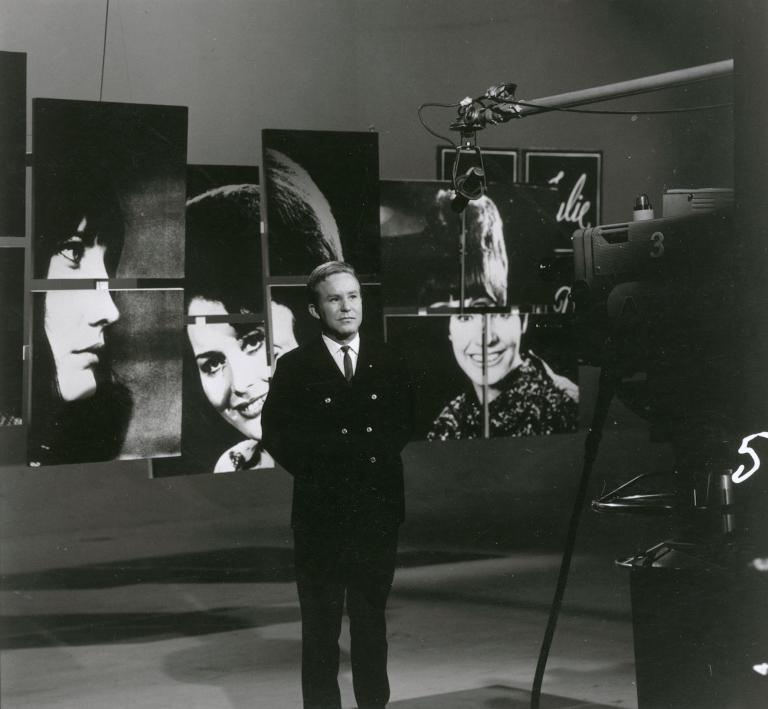 Johnny O'Keefe standing on set in front of boom mic and camera