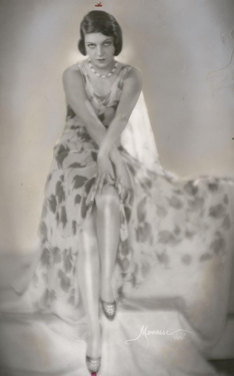 Portrait of actress Kaethe von Nagy, seated with arms crossed in front of her and hands resting on her knee.