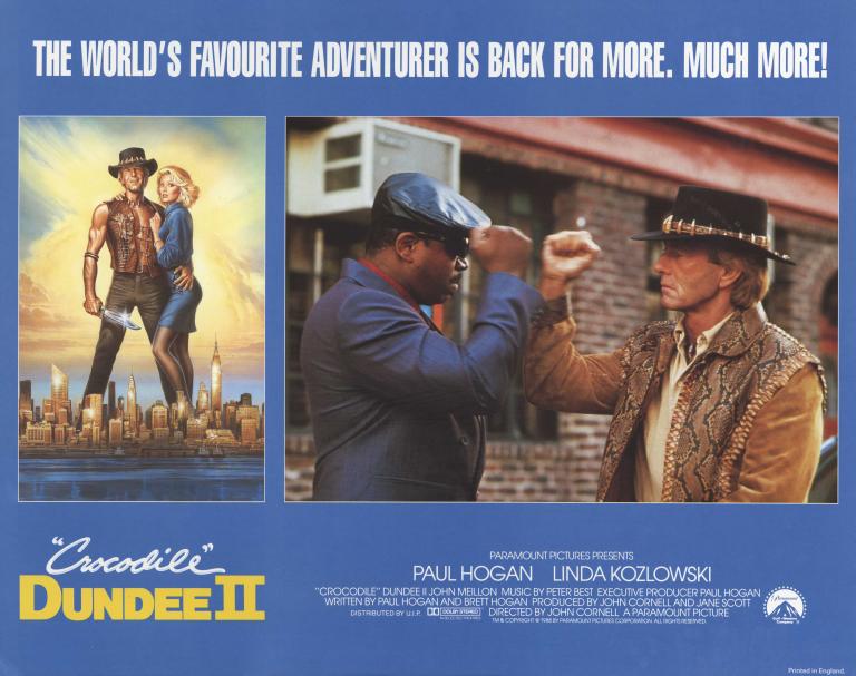 Gus and Mick fistpump A lobby card for Crocodile Dundee II. There is a picture on of Paul Hogan (Mick Dundee) and Linda Kozlowski (Sue Charlton), a picture of Mick fistpumping with Reginald VelJohnson (Gus the driver), and production company, cast and crew information