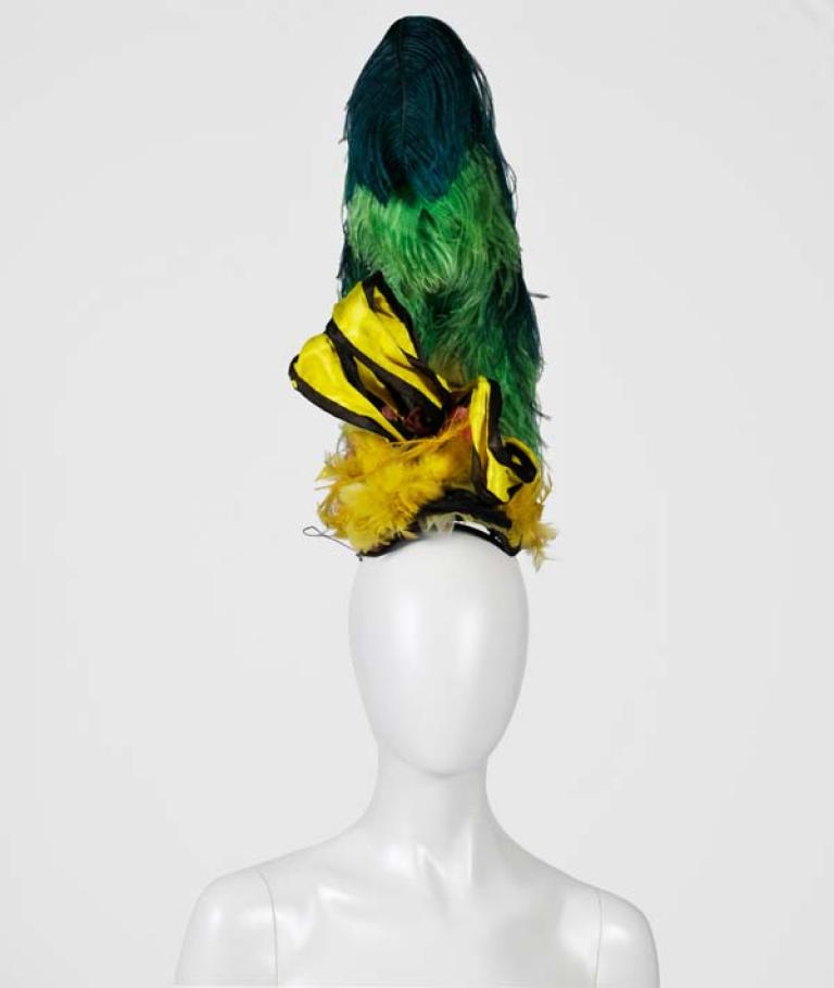 Green and yellow headpiece Green and yellow feathered headpiece from 'The Adventures of Priscilla, Queen of the Desert'.