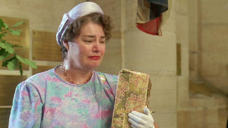 Betty Heslop (Jeanie Drynan) looking sad holding wedding present