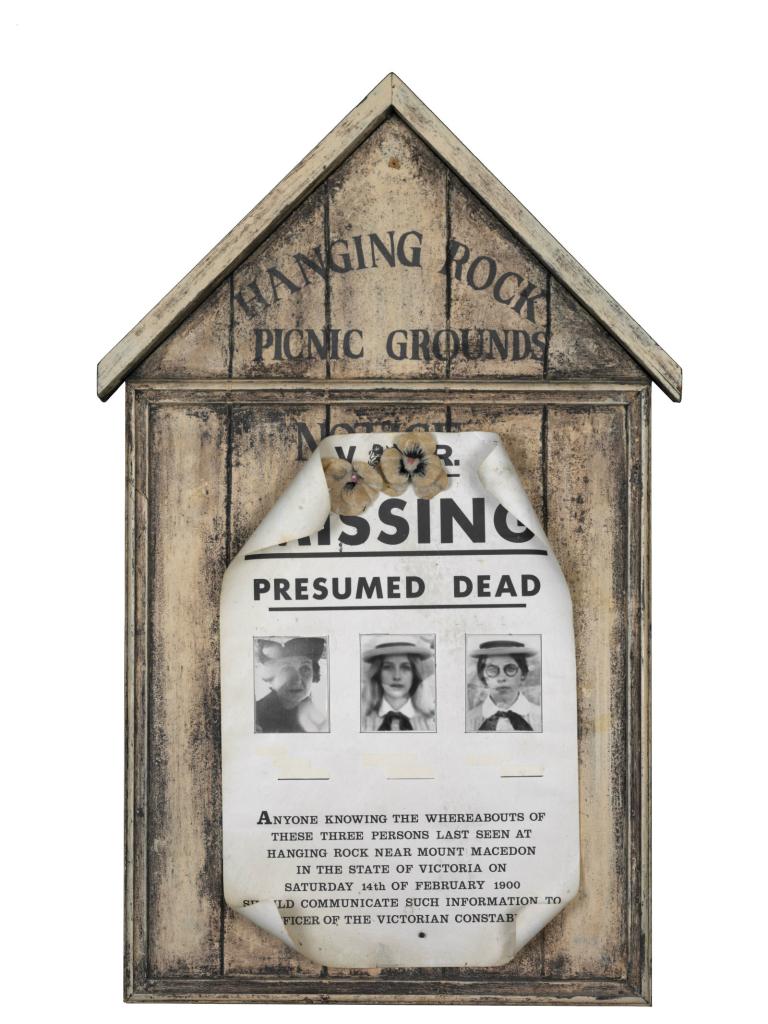 Sign stuck to Hanging Rock Picnic Grounds noticeboard 'Missing Presumed Dead' with pictures of the 3 girls