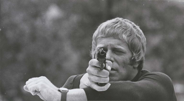 Jack Thompson points a gun at the camera in a 1970 episode of Australian detective TV show Homicide Jack Thompson points a gun at the camera in a 1970 episode of Australian detective TV show Homicide