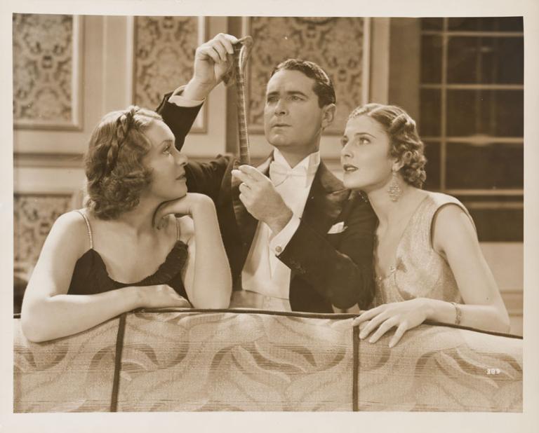 Lovers and Luggers Publicity still of Shirley Ann Richards as Lorna Quidley, Lloyd Hughes as Daubenny Carshott and Elaine Hamill as Stella Raff examining a film strip.