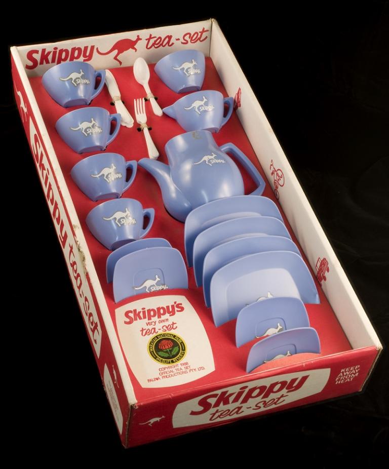 Blue plastic tea set with kangaroo motif in red cardboard box. 'Skippy Tea Set' logo on box. Blue plastic tea set with kangaroo motif in red cardboard box. 'Skippy Tea Set' logo on box.