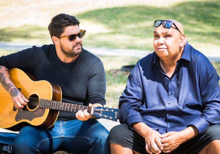 Dan Sultan and Kutcha Edwards Indigenous singer/songwriter Dan Sultan, pictured outdoors seated with a guitar next to TV presenter and performer Kutcha Edwards.
