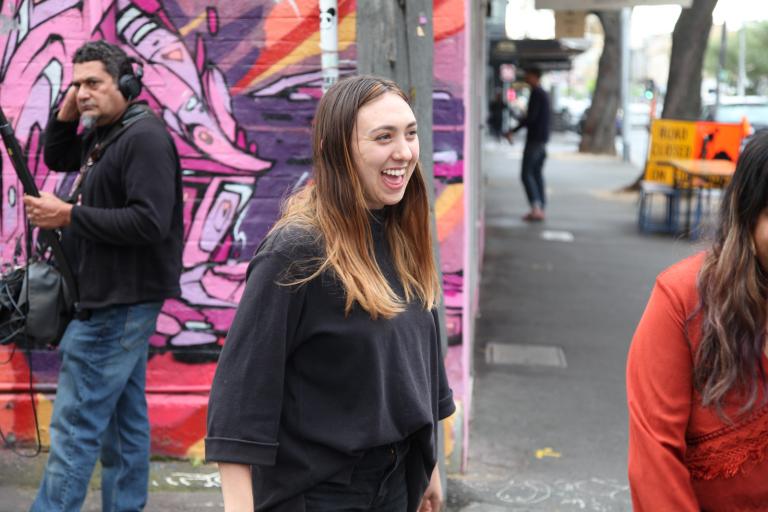 Alice Skye Indigenous performer Alice Skye standing in a Melbourne street with a graffitied wall behind her.