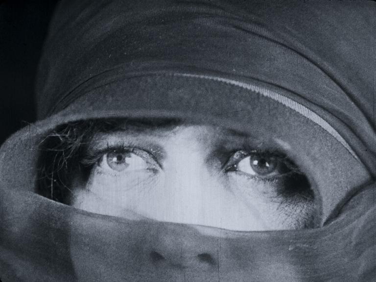 Black and white frame capture from the film, The Cheaters, showing a bog close up of a woman's eyes