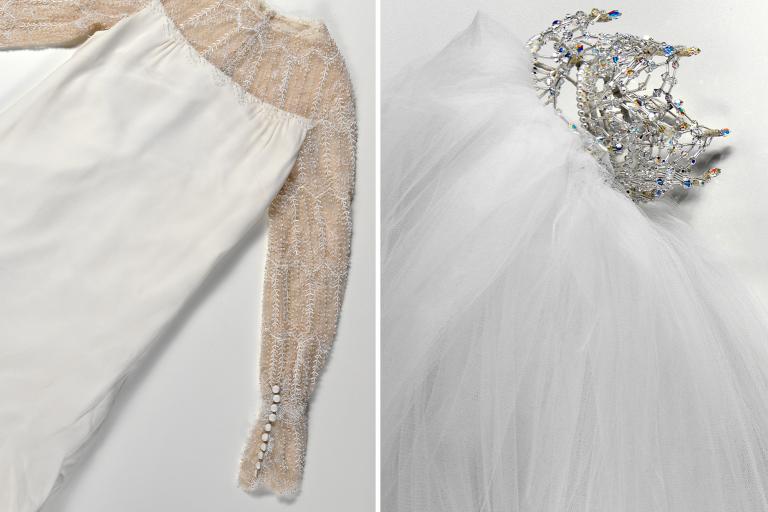 A wedding dress with lace around the neckline and sleeves, pictured next to a veil and tiara.
