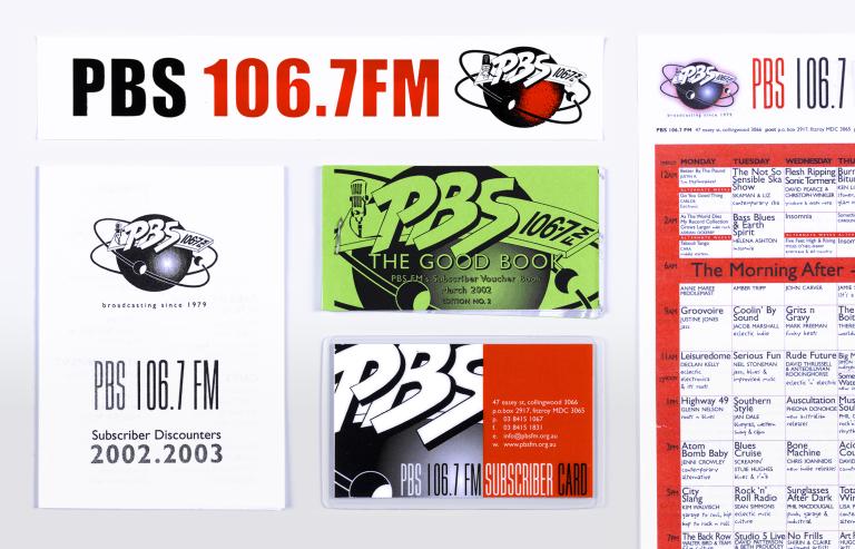A selection of printed ephemera from radio station PBS 106.7 FM including subscriber discount books, subscriber card, sticker and program schedule.
