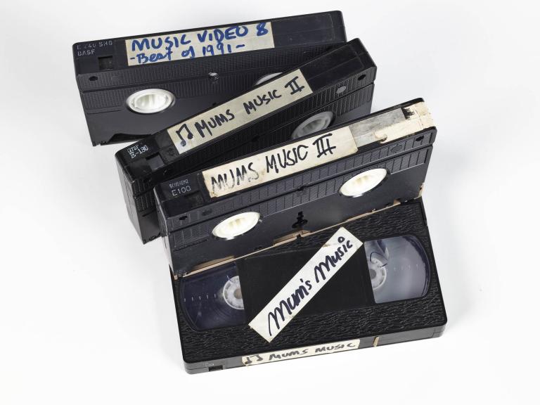 A photo of 4 VHS tapes against a white background. 