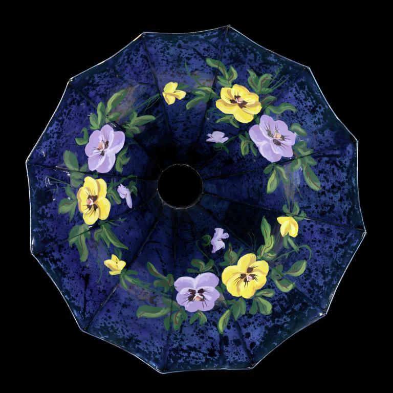 A photo of a floral-decorated sound horn painted on a blue background. 